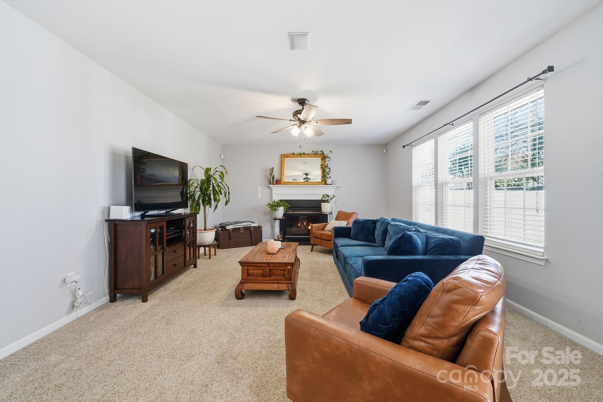 110 Nahcotta Drive Mooresville, NC 28115 - Photo 7 of 29 a living room with furniture and a flat screen tv