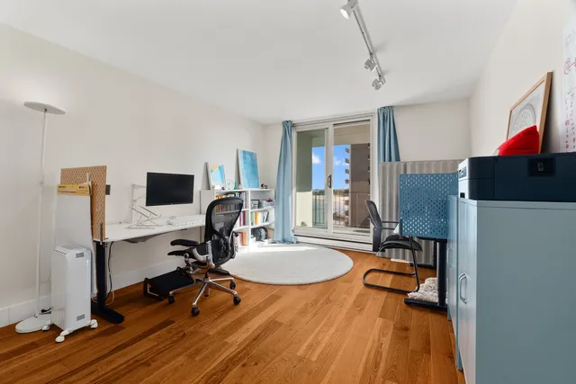 a view of a workspace with furniture and a bathroom