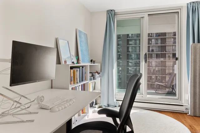 a bedroom with furniture and a large window