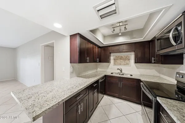a large kitchen with a stove and a refrigerator