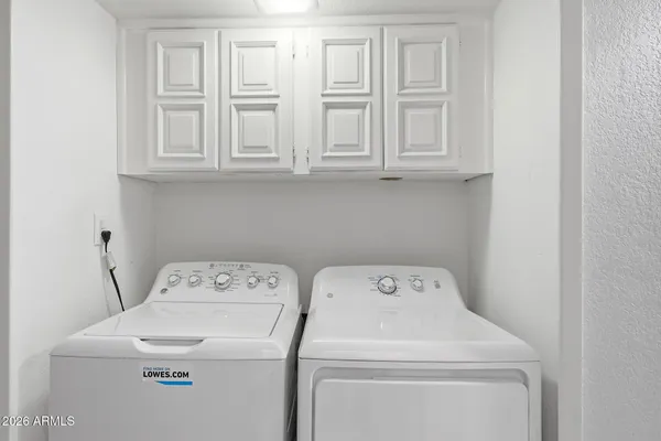 a roof deck with couches and potted plants