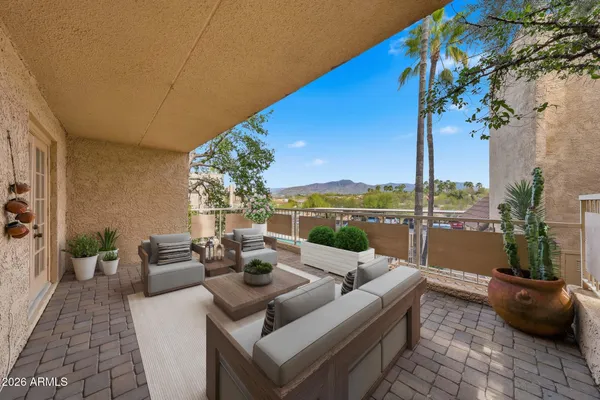 a living room with furniture and a potted plant