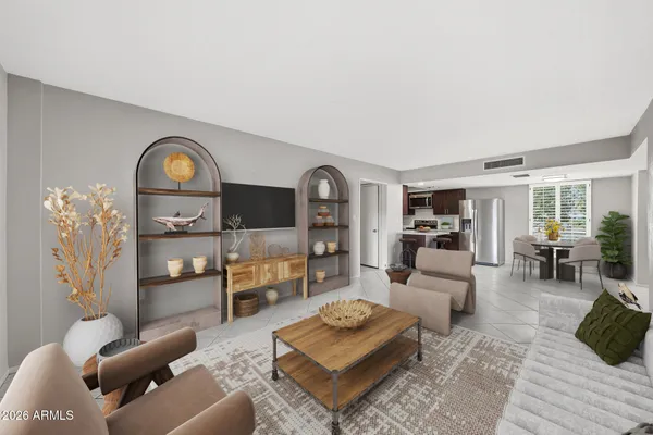 a living room with furniture and a wooden floor