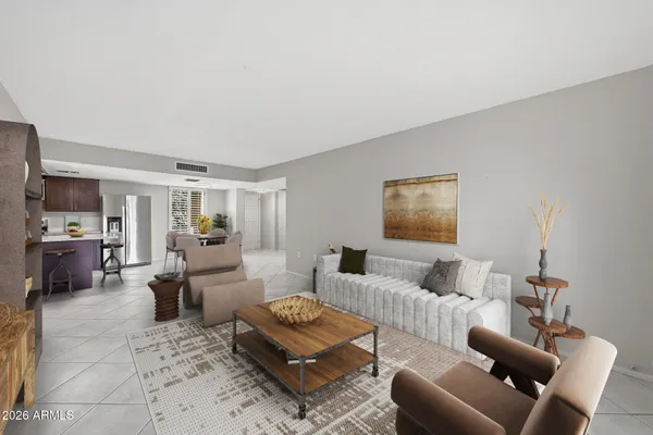 a living room with furniture a flat screen tv and kitchen view