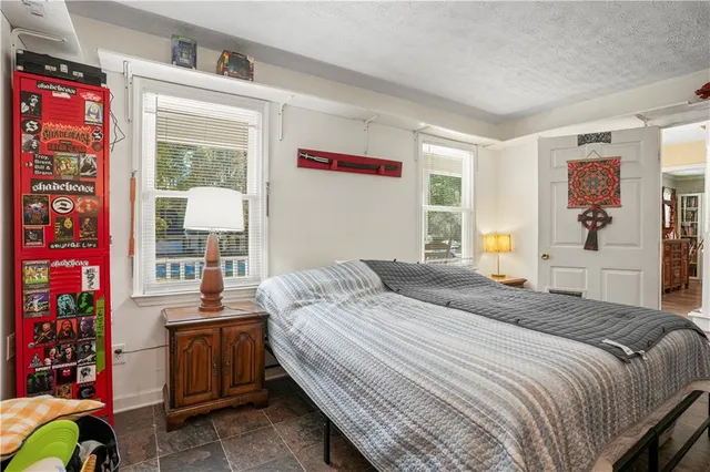 a bedroom with a bed and a window