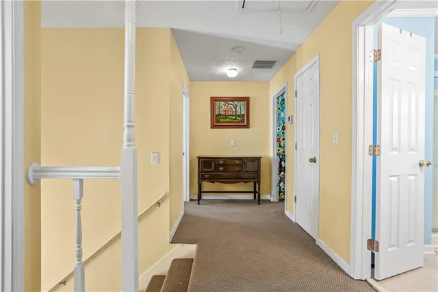 a view of a hallway with wooden shelves