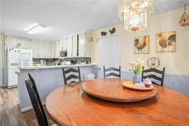 a dining room with furniture and wooden floor