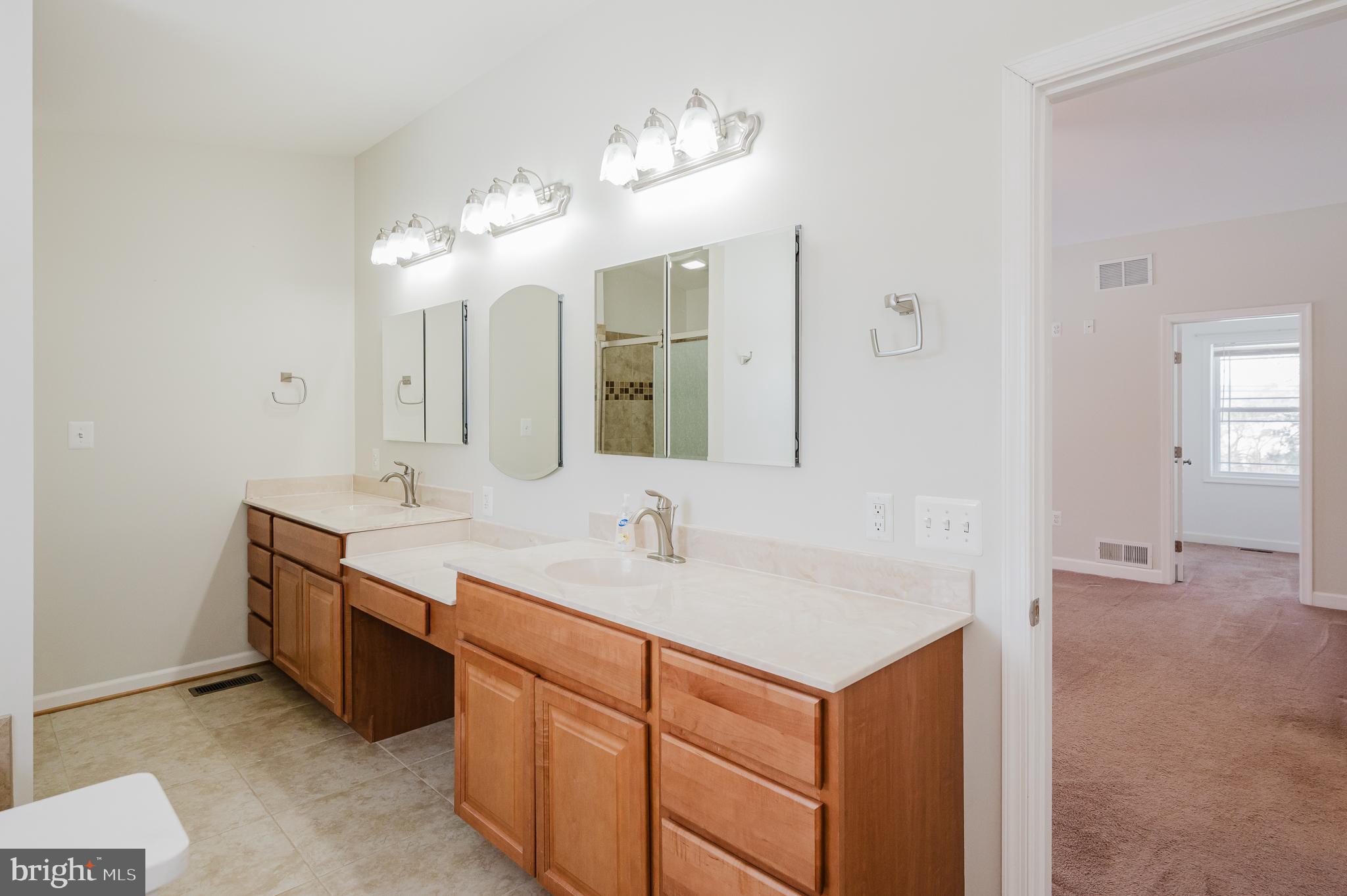2210 Pleasantville Road Fallston, MD 21047 - Photo 25 of 56 a bathroom with a double vanity sink and a mirror