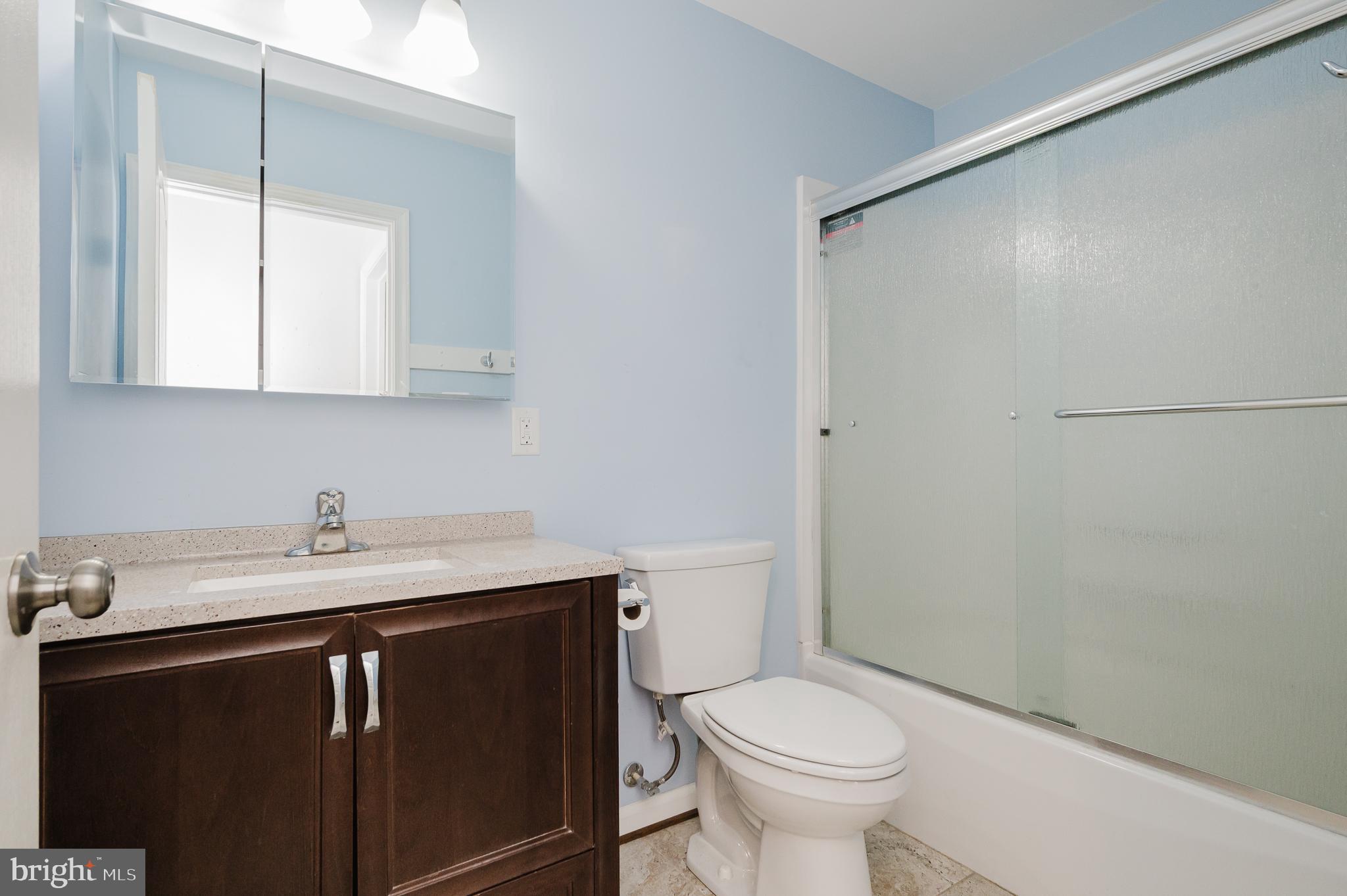 2210 Pleasantville Road Fallston, MD 21047 - Photo 30 of 56 a bathroom with a granite countertop sink toilet and a mirror