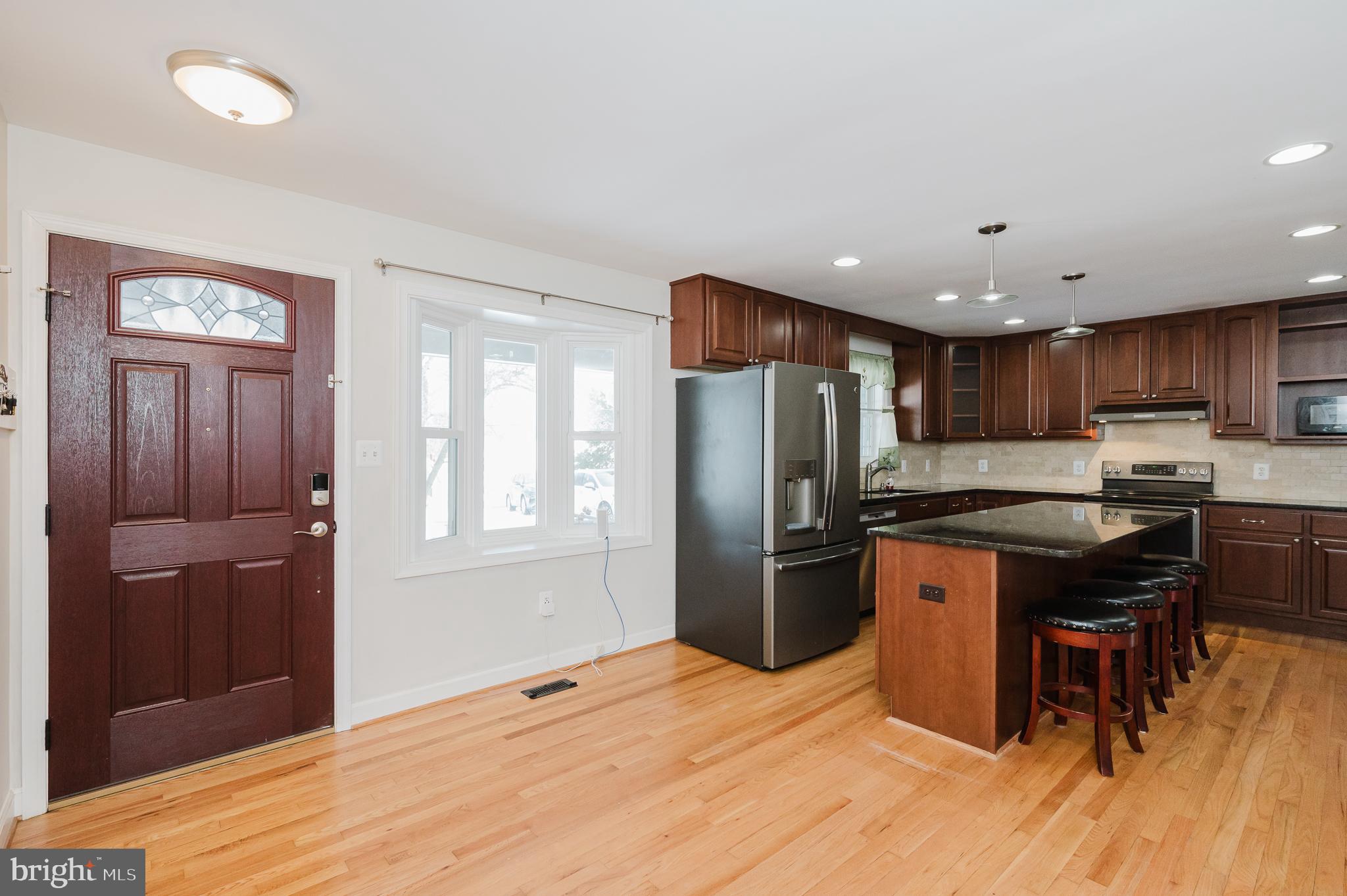 2210 Pleasantville Road Fallston, MD 21047 - Photo 4 of 56 a kitchen with stainless steel appliances granite countertop a refrigerator a sink dishwasher and a stove with wooden floors