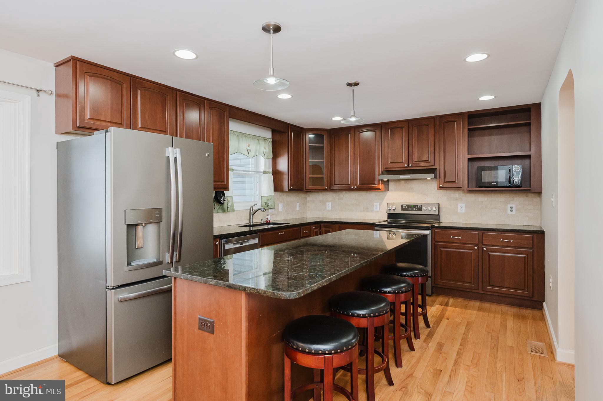 2210 Pleasantville Road Fallston, MD 21047 - Photo 5 of 56 a kitchen with stainless steel appliances granite countertop a refrigerator stove microwave and sink
