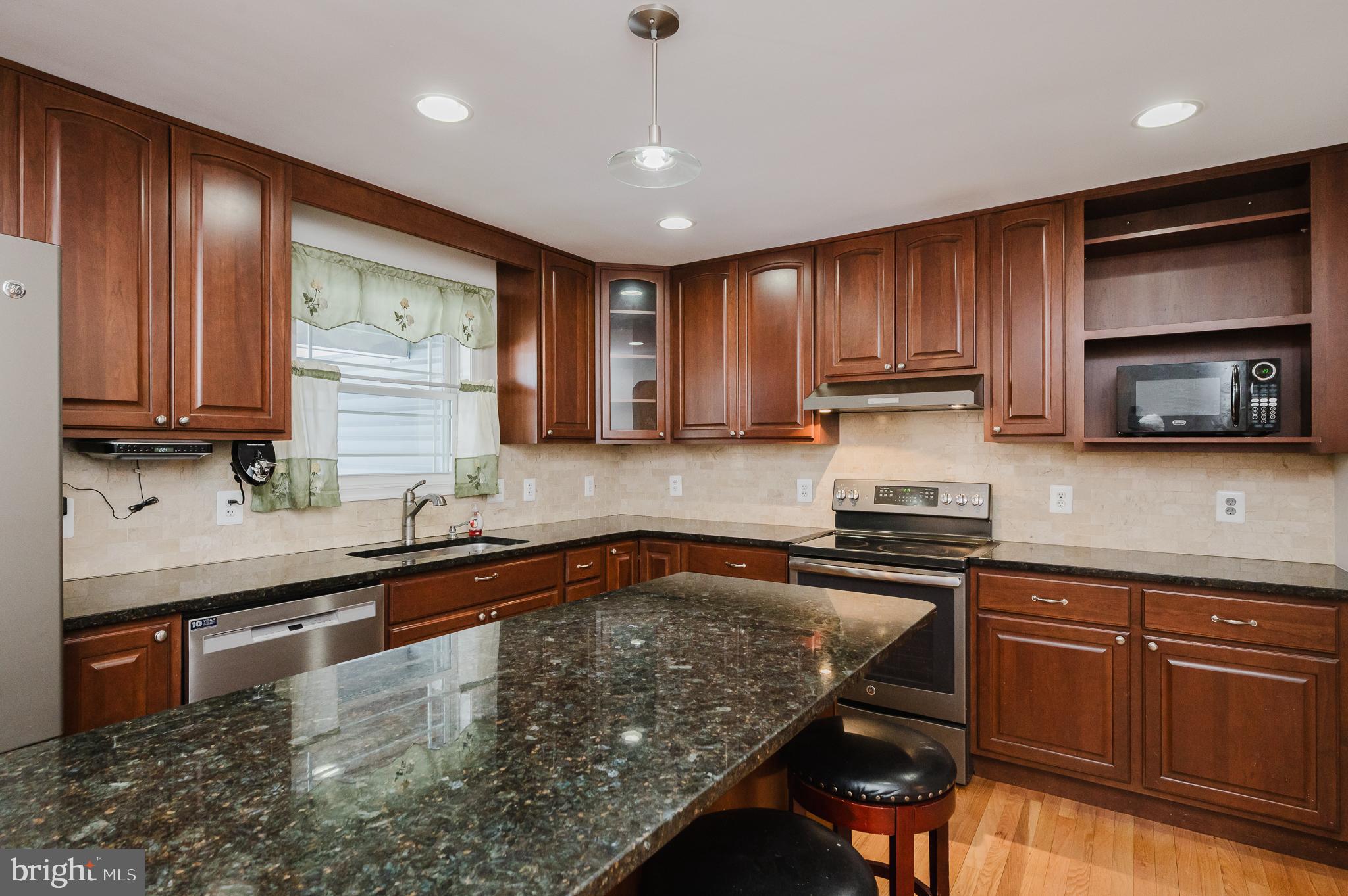 2210 Pleasantville Road Fallston, MD 21047 - Photo 6 of 56 a kitchen with stainless steel appliances granite countertop wooden cabinets a stove top oven a sink and dishwasher