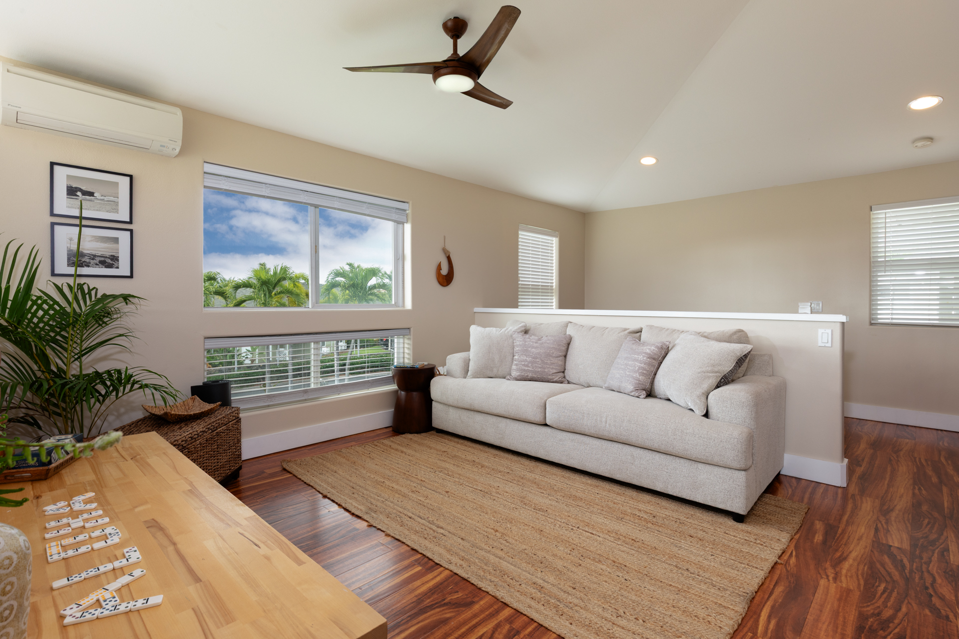75-6009 Alii Drive, Unit A4 Kailua-Kona, HI 96740 - Photo 14 of 27 a living room with furniture and a window