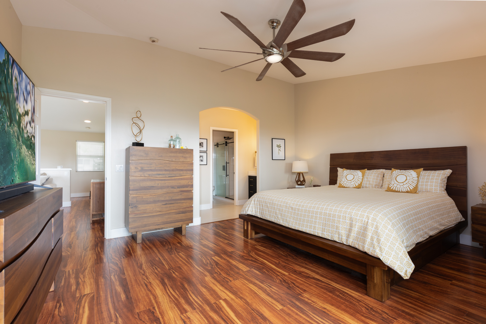 75-6009 Alii Drive, Unit A4 Kailua-Kona, HI 96740 - Photo 17 of 27 a bedroom with a bed and wooden floor