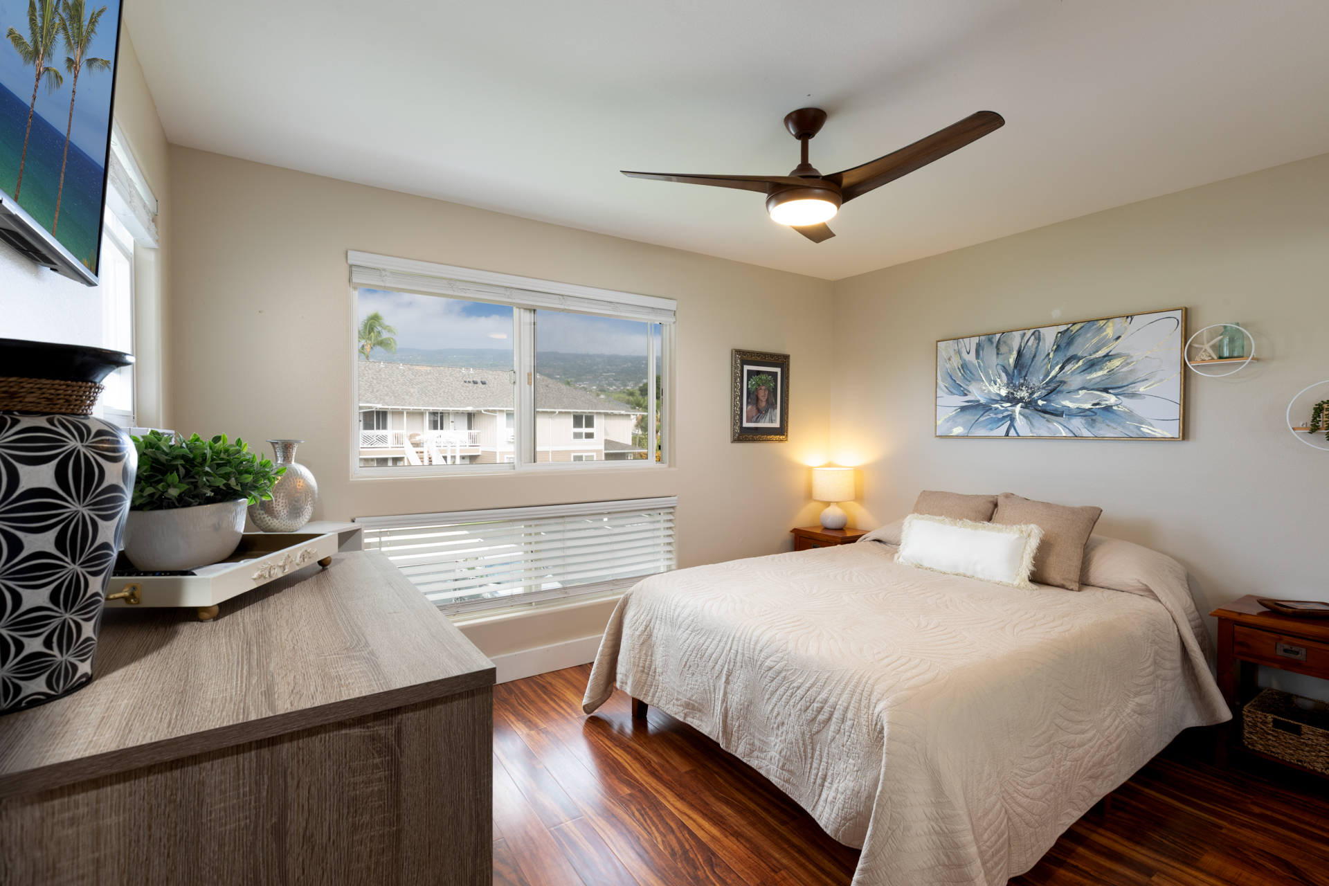 75-6009 Alii Drive, Unit A4 Kailua-Kona, HI 96740 - Photo 19 of 27 a bedroom with a bed window and a table