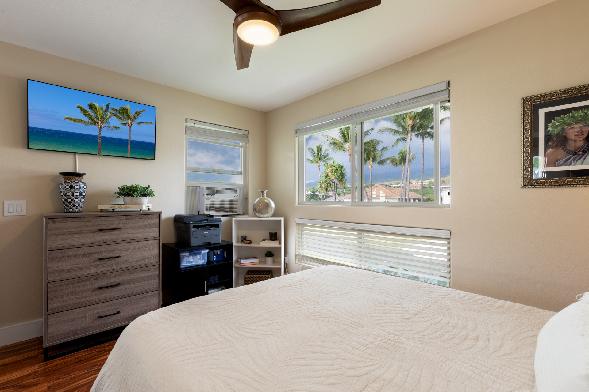 75-6009 Alii Drive, Unit A4 Kailua-Kona, HI 96740 - Photo 20 of 27 a bedroom with a bed and a dresser