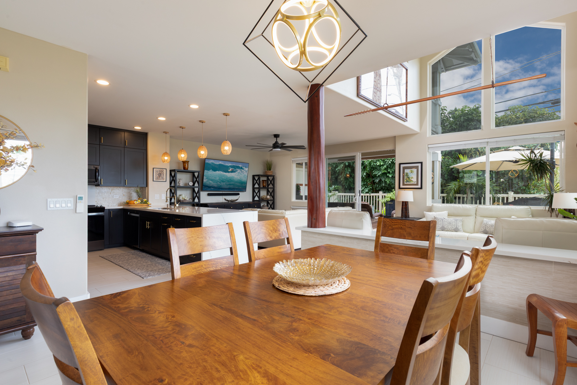 75-6009 Alii Drive, Unit A4 Kailua-Kona, HI 96740 - Photo 10 of 27 a living room with kitchen island furniture and a large window