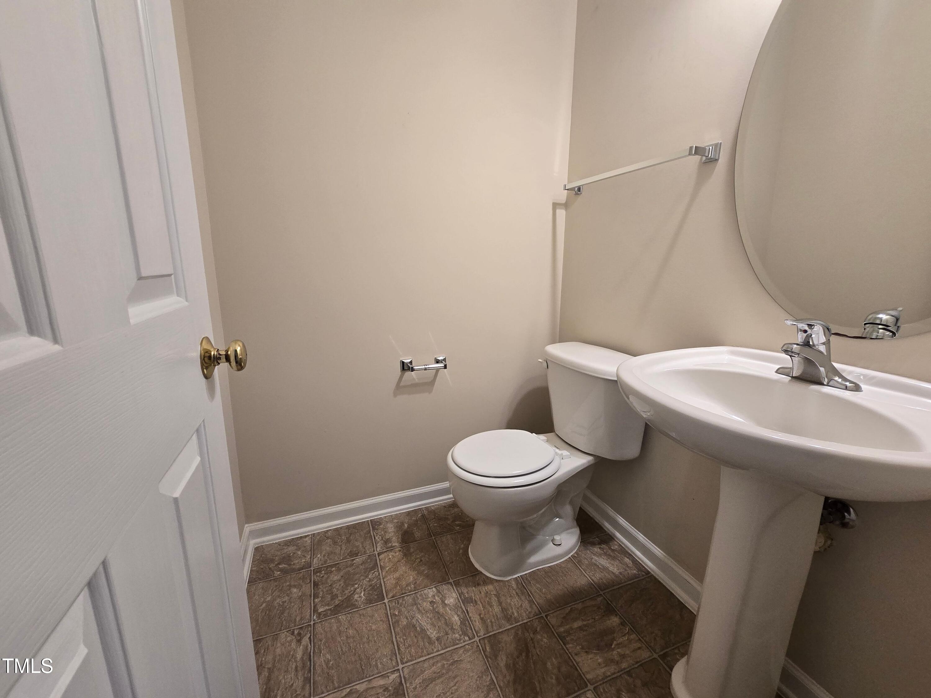 2330 Lazy River Drive Raleigh, NC 27610 - Photo 11 of 31 a bathroom with a sink toilet and a mirror