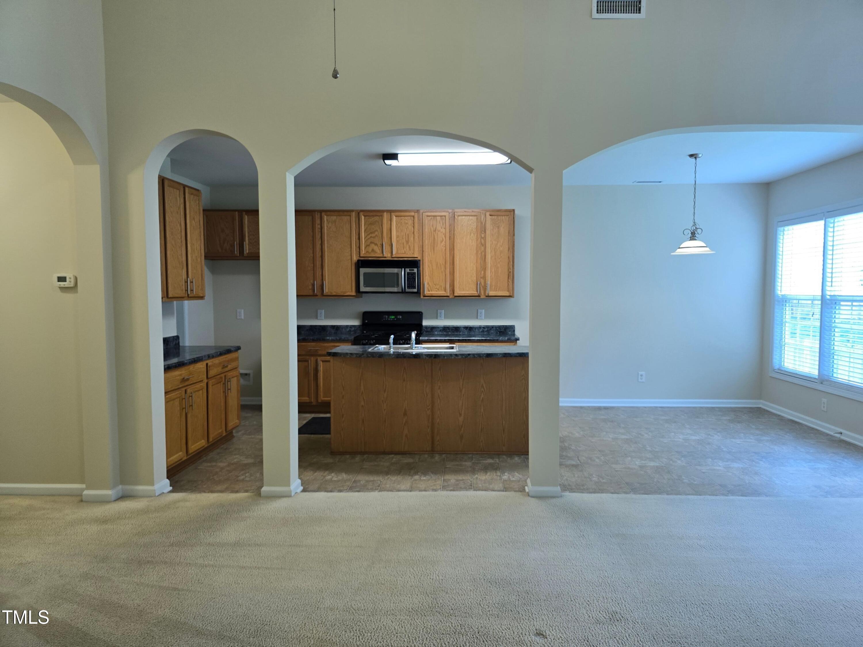 2330 Lazy River Drive Raleigh, NC 27610 - Photo 14 of 31 a view of kitchen with refrigerator and cabinets