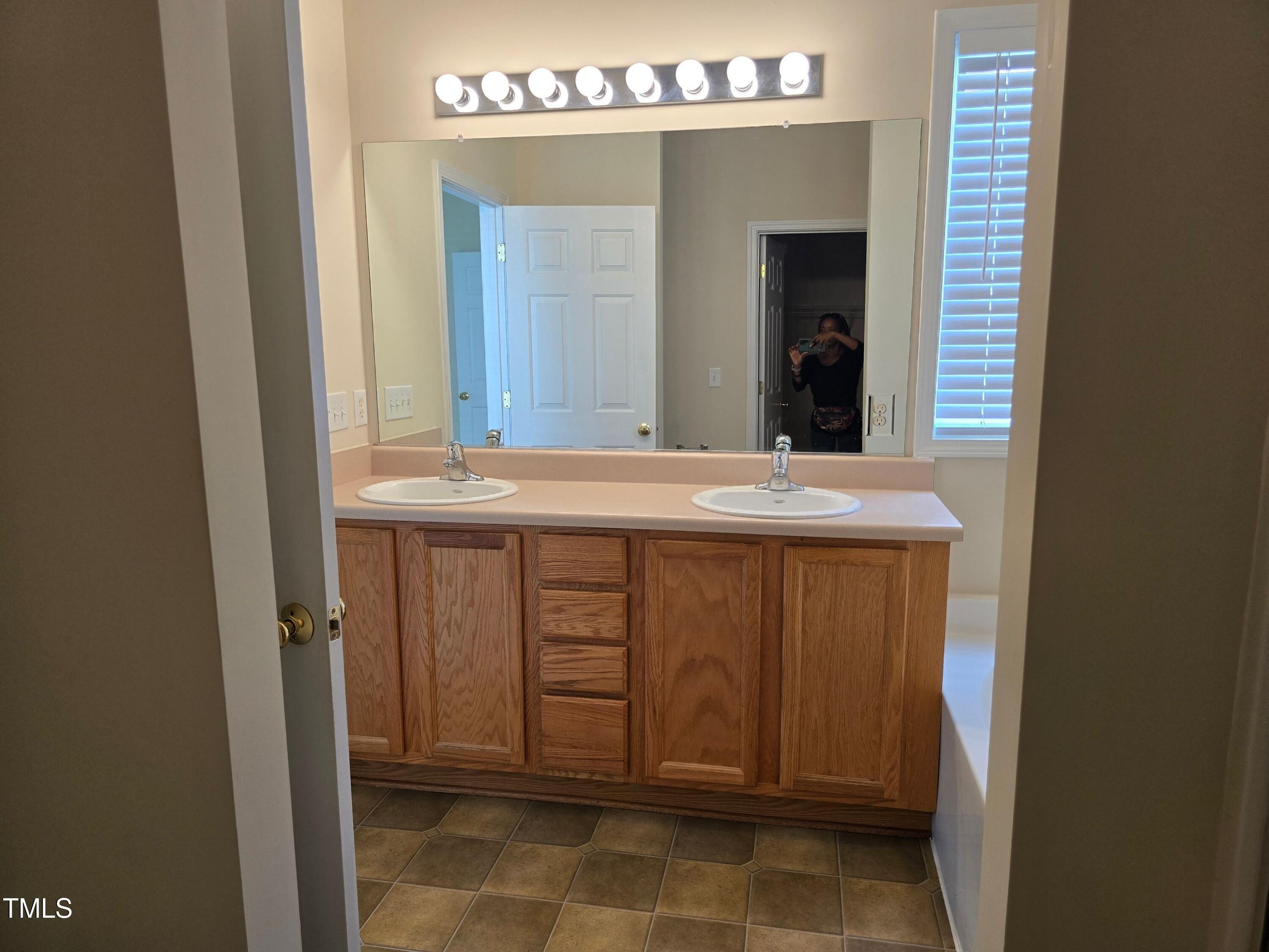 2330 Lazy River Drive Raleigh, NC 27610 - Photo 22 of 31 a bathroom with a sink and a mirror