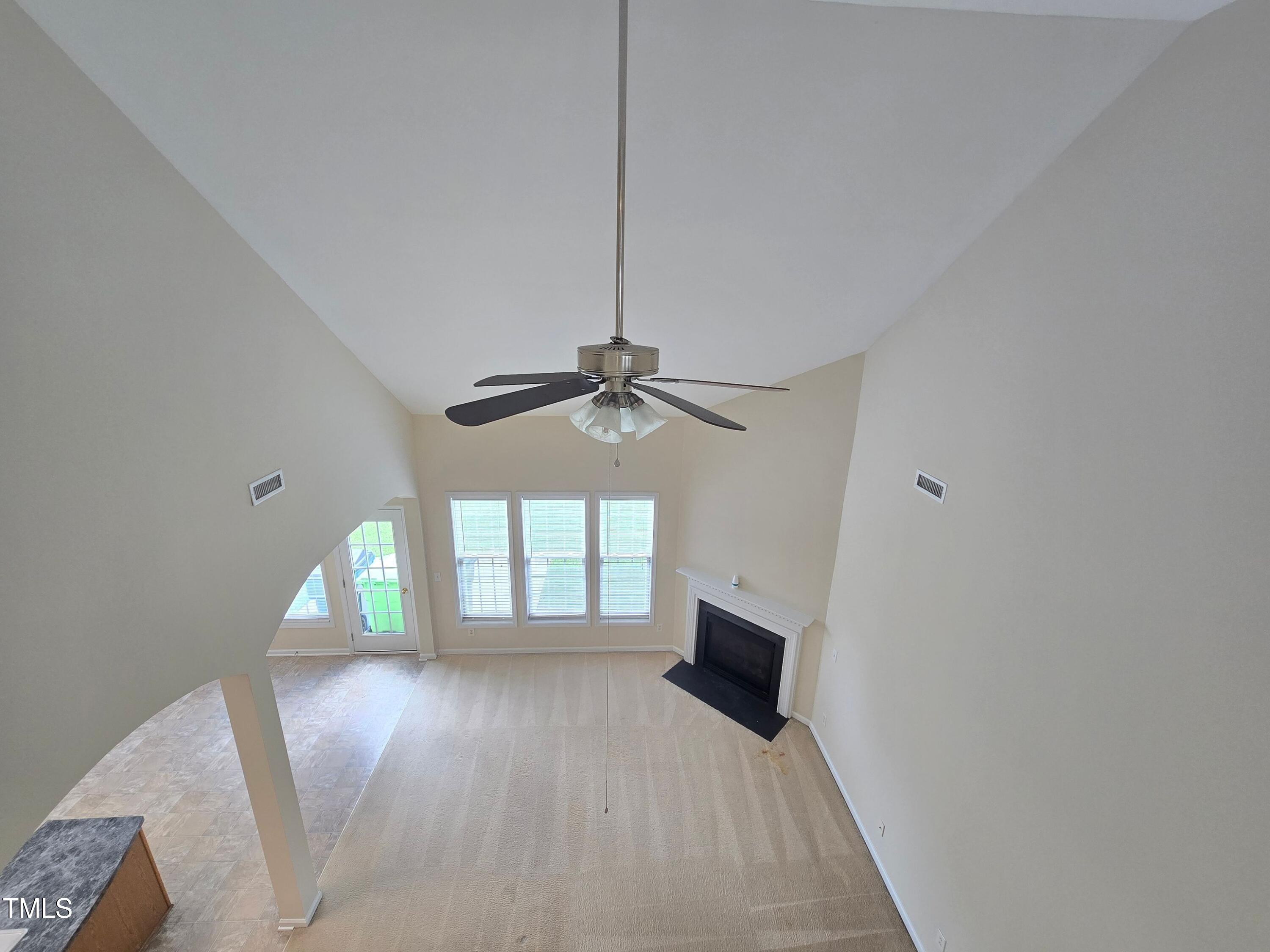 2330 Lazy River Drive Raleigh, NC 27610 - Photo 27 of 31 a view of empty room with wooden floor and fan