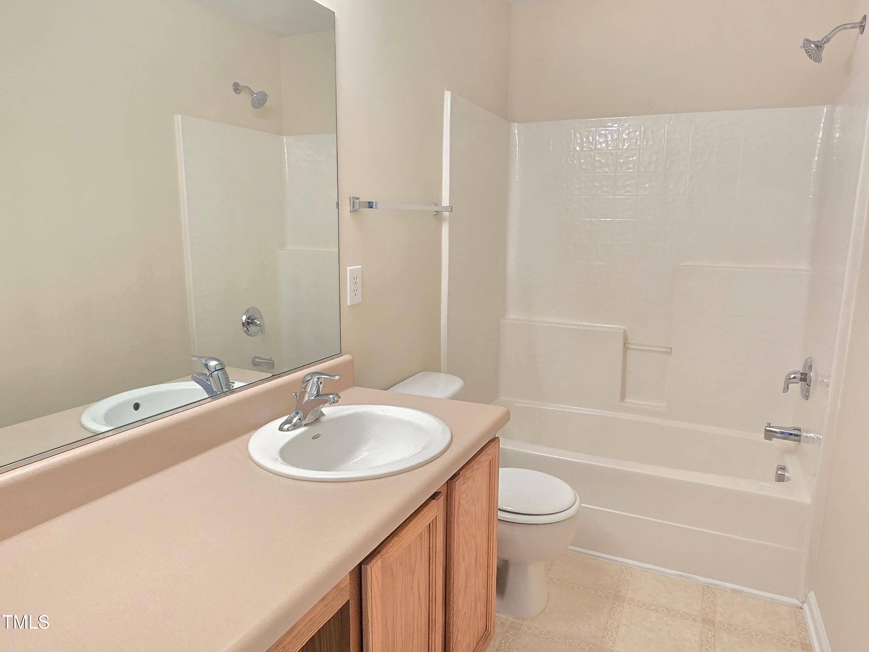 2330 Lazy River Drive Raleigh, NC 27610 - Photo 29 of 31 a bathroom with a sink a toilet and shower