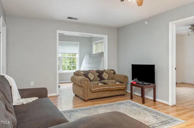 a view of hallway with wooden floor