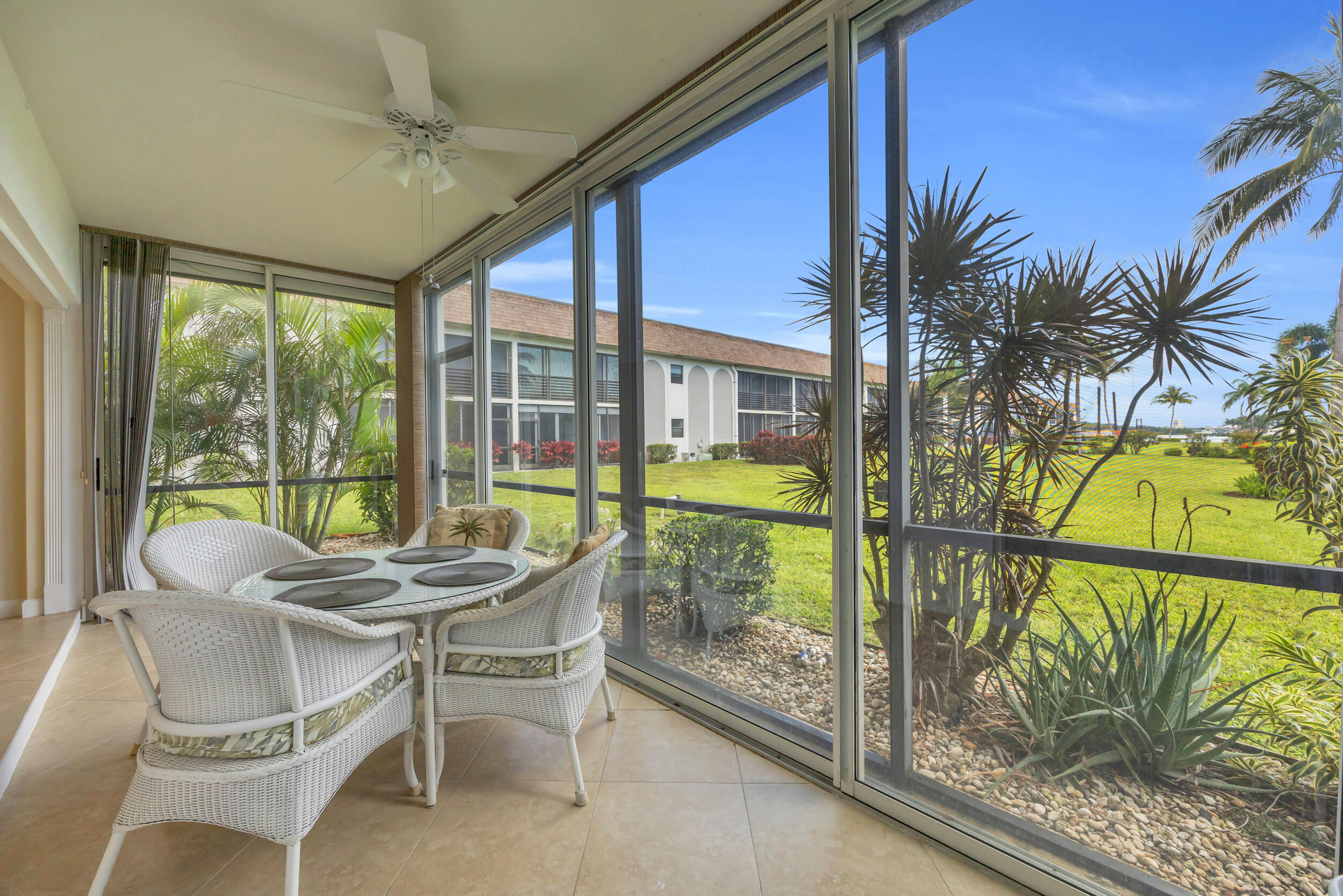 755 Saturn Street, Unit G101 Jupiter, FL 33477 - Photo 12 of 31 a dining room with furniture and a floor to ceiling window