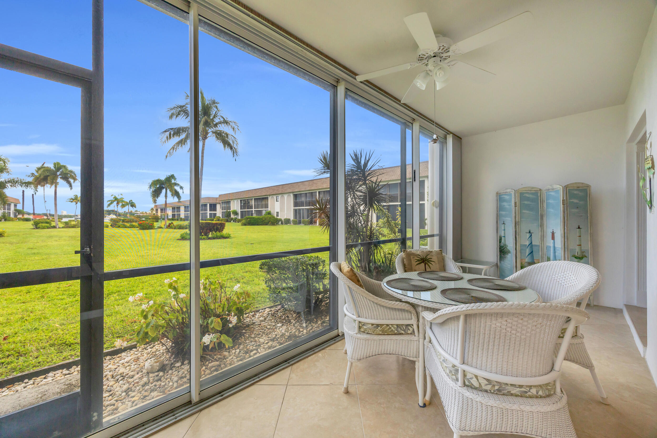755 Saturn Street, Unit G101 Jupiter, FL 33477 - Photo 13 of 31 a dining room with furniture and a floor to ceiling window