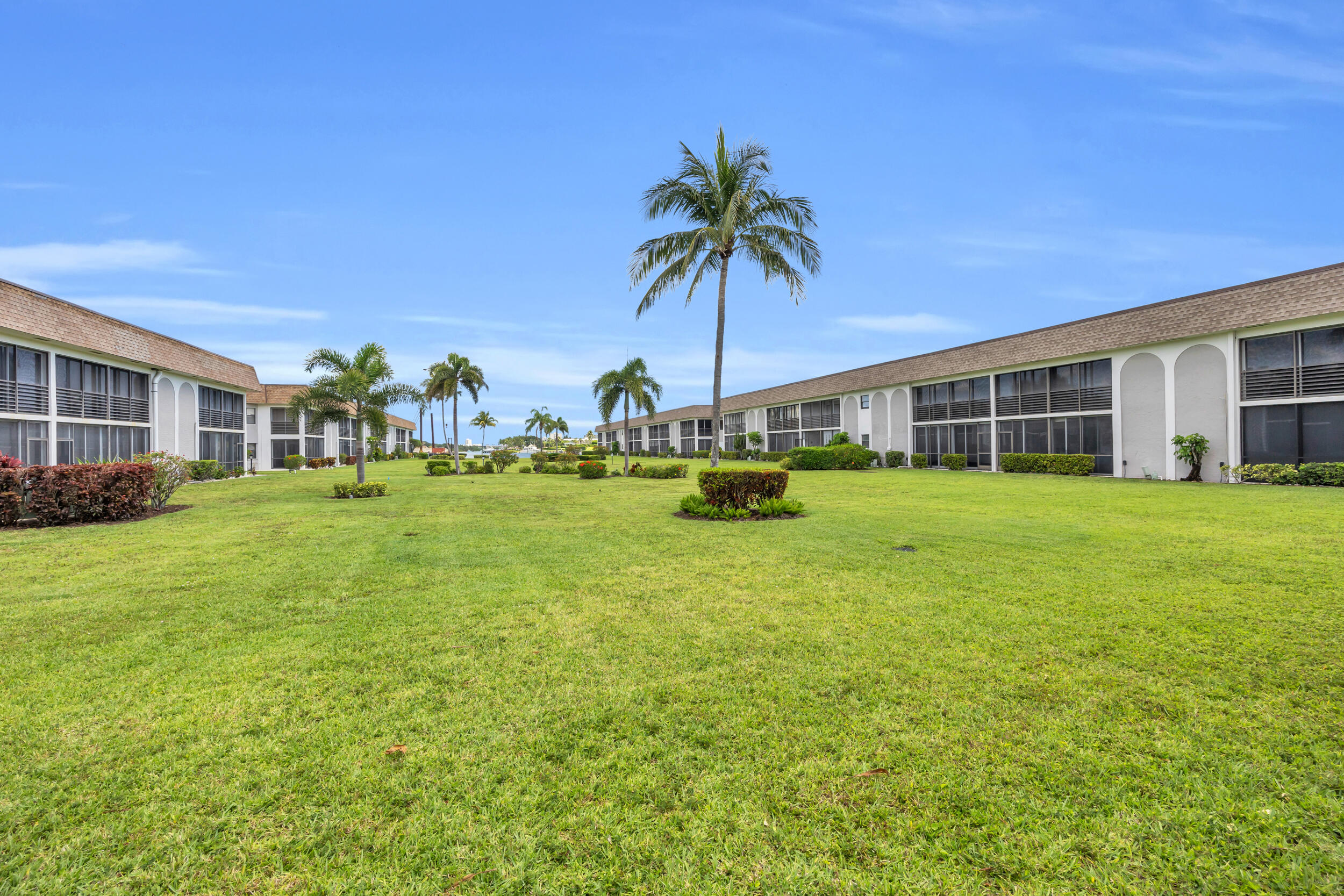 755 Saturn Street, Unit G101 Jupiter, FL 33477 - Photo 15 of 31 a view of a house with yard and sitting area