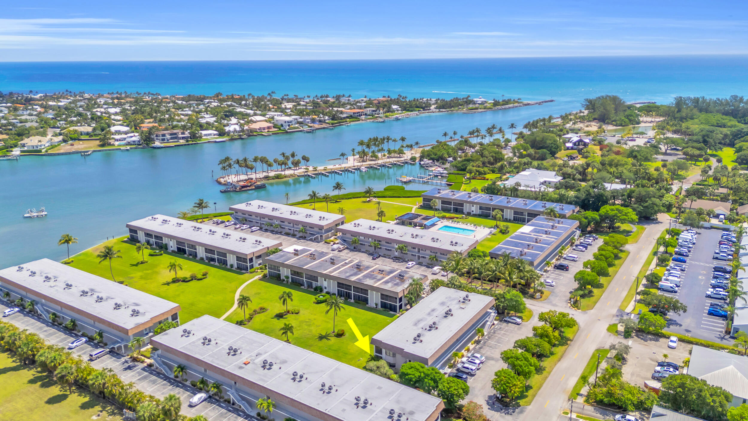 755 Saturn Street, Unit G101 Jupiter, FL 33477 - Photo 20 of 31 an aerial view of a pool patio swimming pool and ocean view
