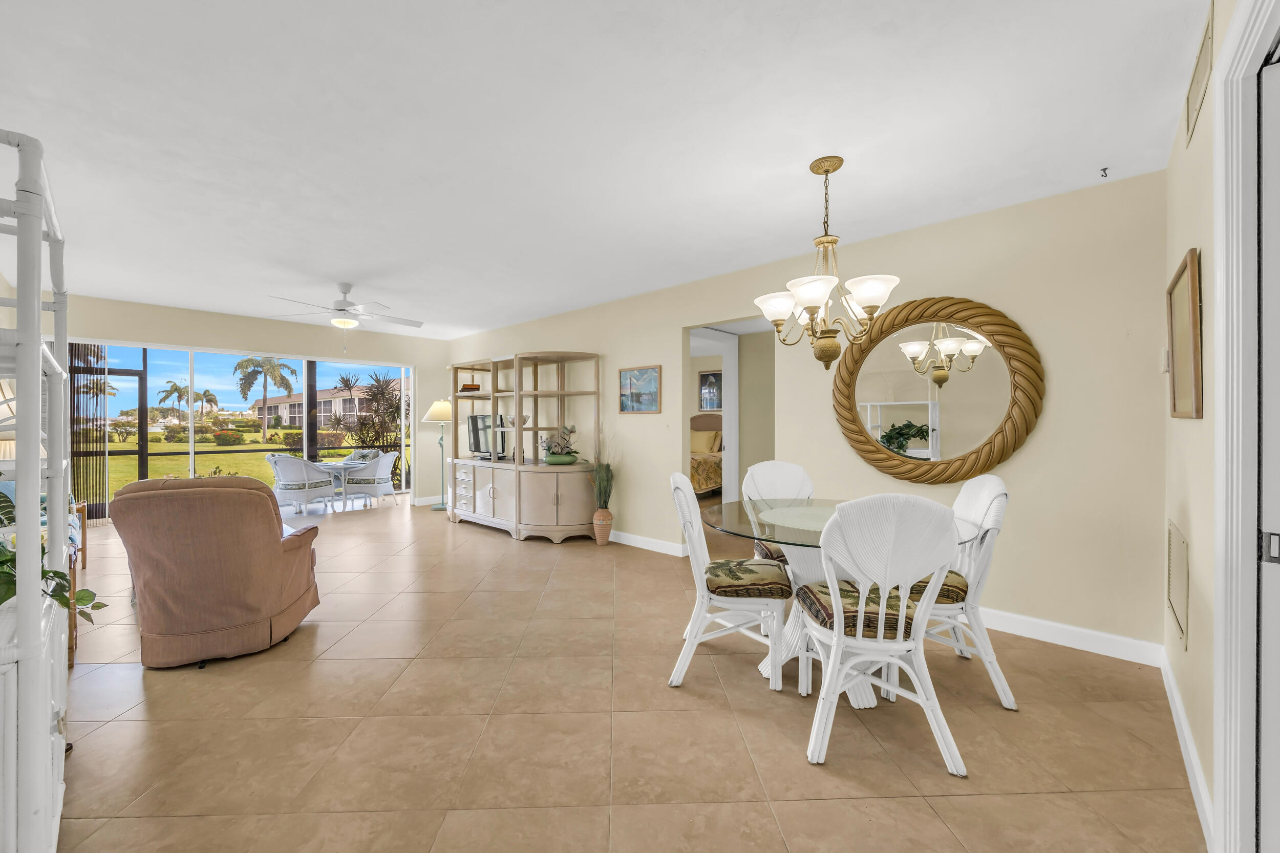 755 Saturn Street, Unit G101 Jupiter, FL 33477 - Photo 2 of 31 a living room with furniture a rug and a clock