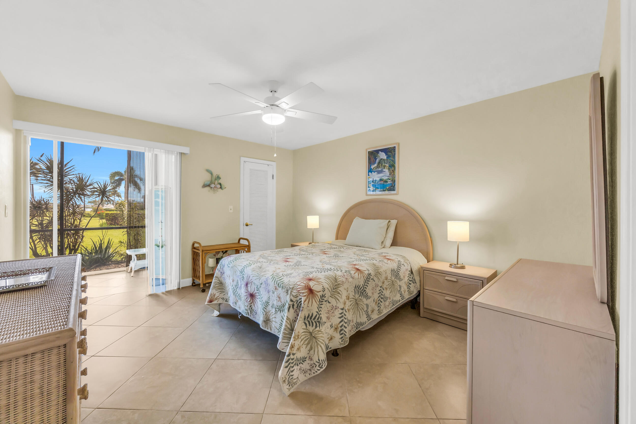 755 Saturn Street, Unit G101 Jupiter, FL 33477 - Photo 23 of 31 a bedroom with a bed and lamp