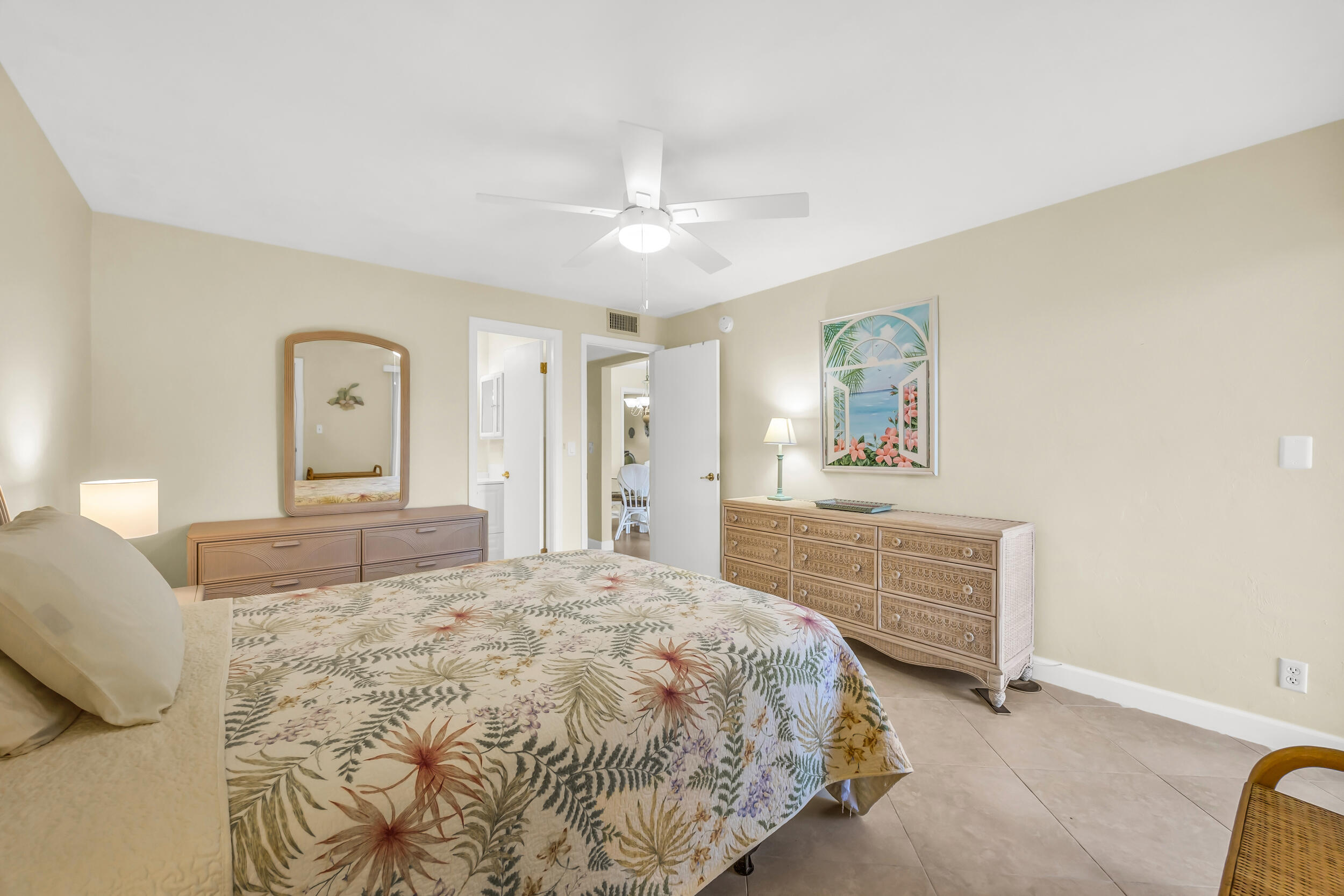 755 Saturn Street, Unit G101 Jupiter, FL 33477 - Photo 24 of 31 a bedroom with a bed and a painting on the wall