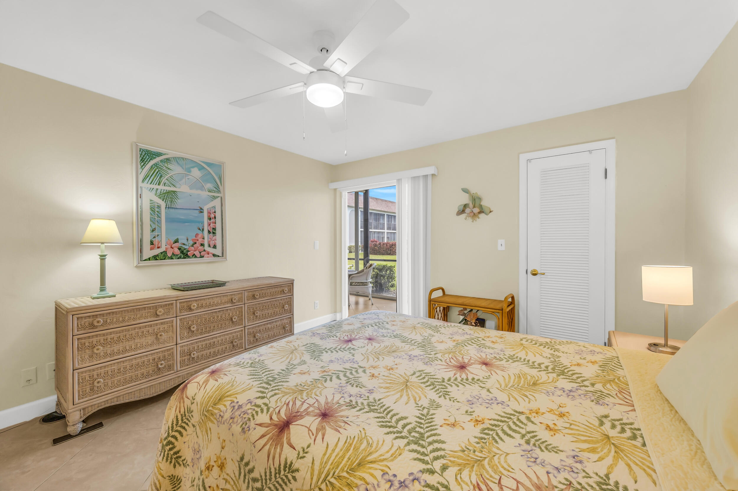 755 Saturn Street, Unit G101 Jupiter, FL 33477 - Photo 26 of 31 a bedroom with a large bed and a chandelier
