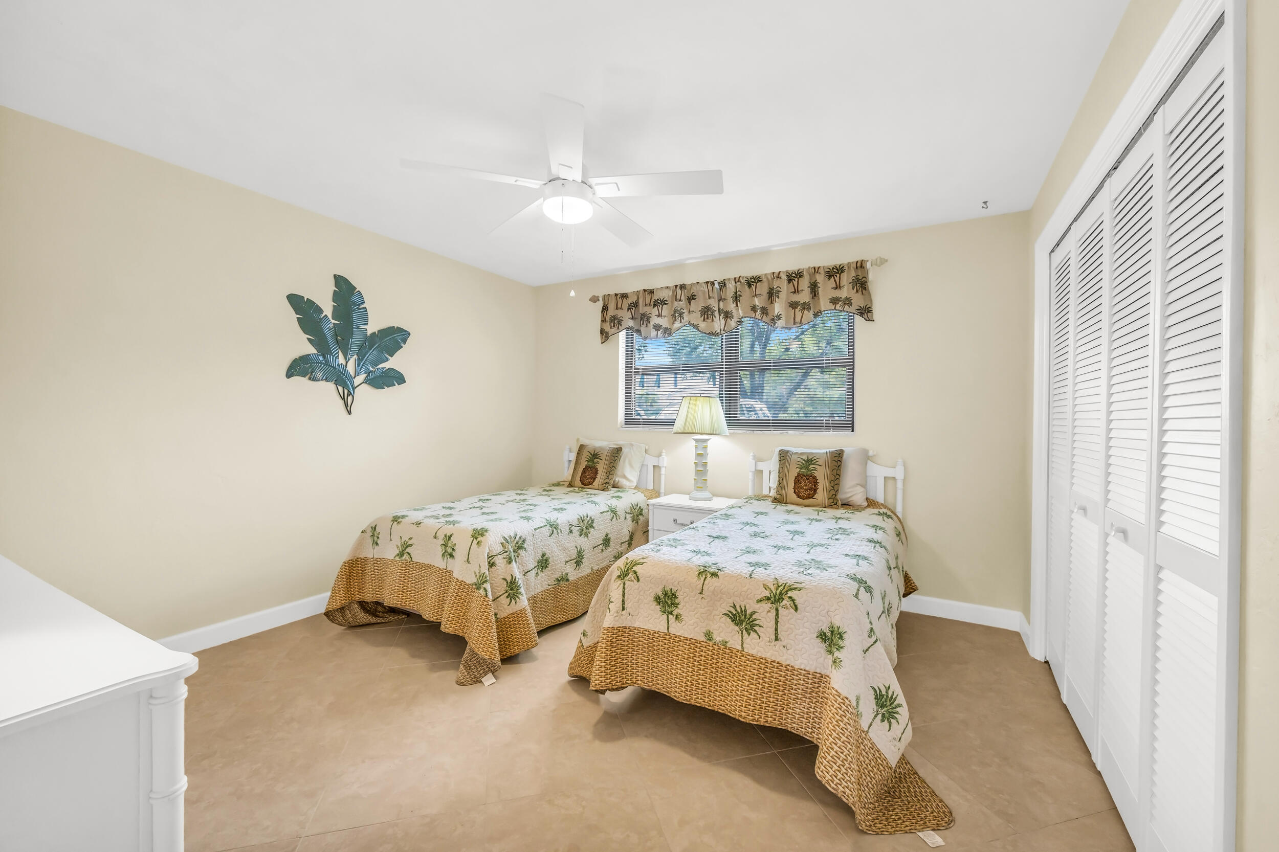 755 Saturn Street, Unit G101 Jupiter, FL 33477 - Photo 28 of 31 a bedroom with two beds and a large window