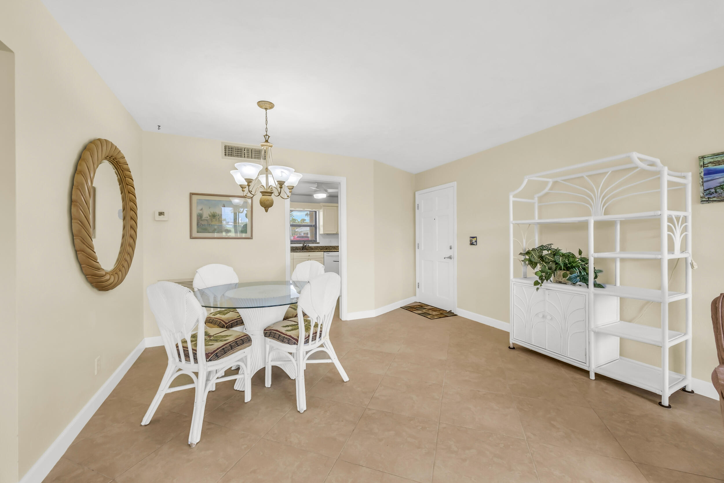 755 Saturn Street, Unit G101 Jupiter, FL 33477 - Photo 3 of 31 a dining room with furniture and chandelier