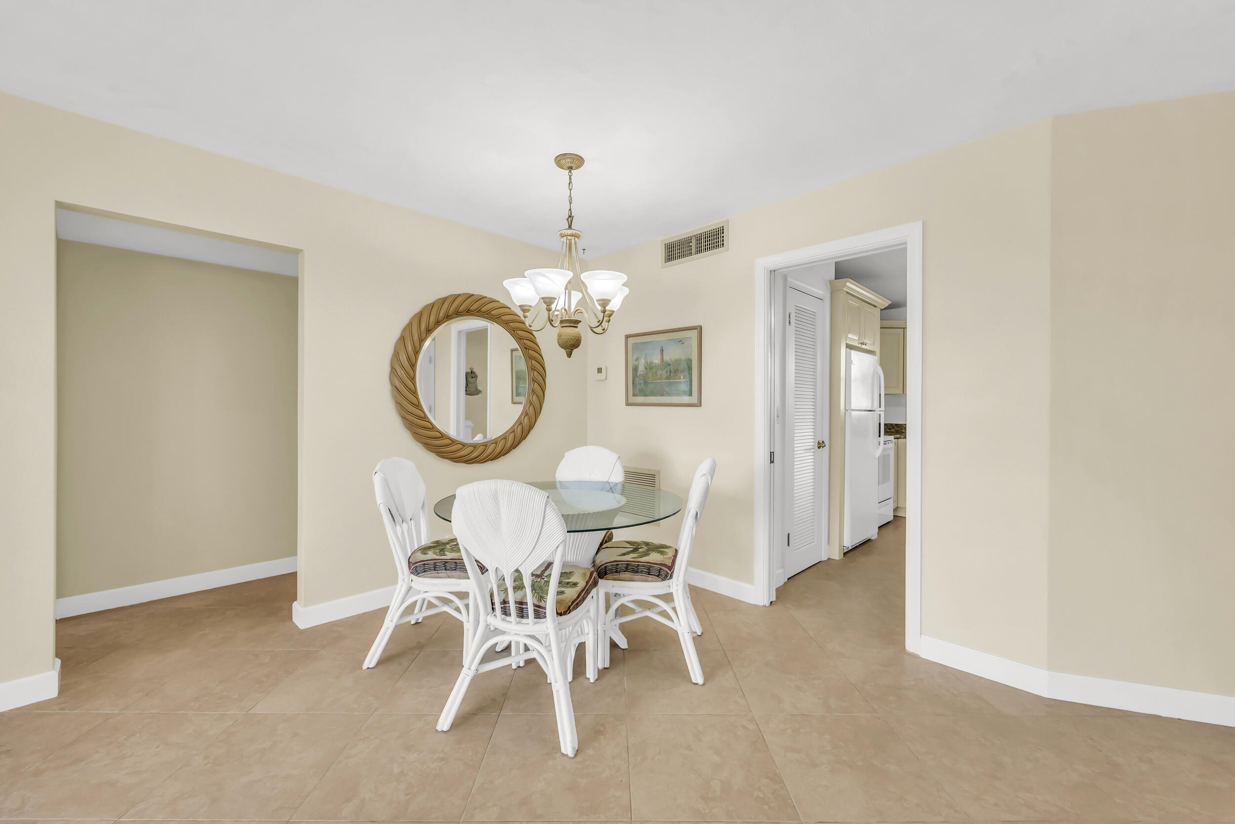 755 Saturn Street, Unit G101 Jupiter, FL 33477 - Photo 4 of 31 a view of a dining room with furniture and a chandelier