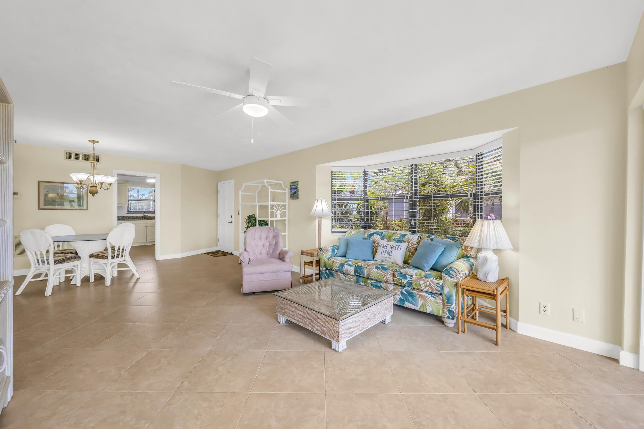 755 Saturn Street, Unit G101 Jupiter, FL 33477 - Photo 9 of 31 a living room with furniture and a table