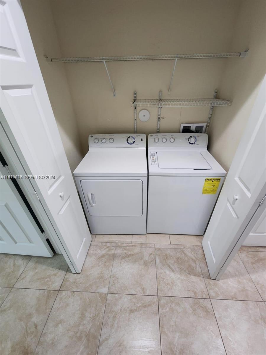 17005 Southwest 96th Street, Unit MAIN Miami, FL 33196 - Photo 11 of 19 a utility room with dryer and washer