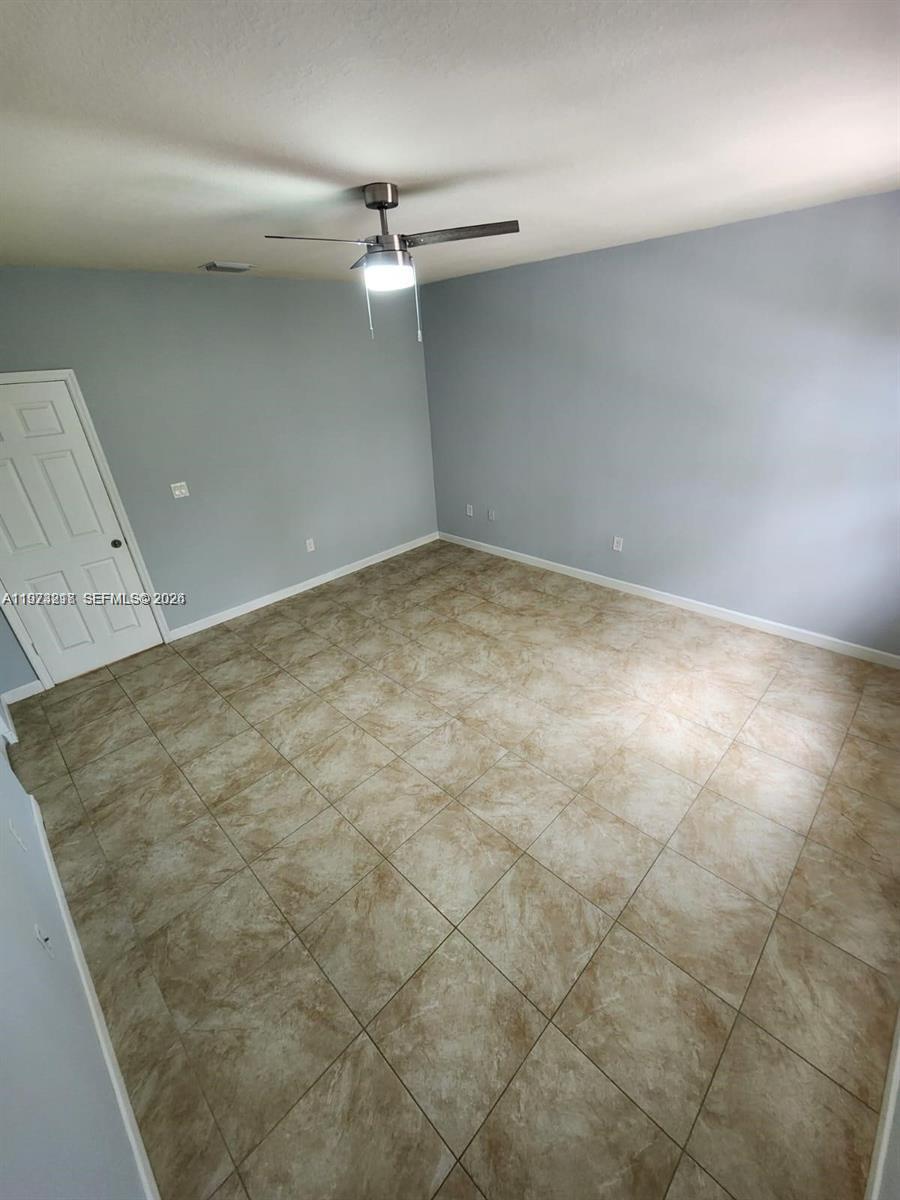 17005 Southwest 96th Street, Unit MAIN Miami, FL 33196 - Photo 13 of 19 en empty room with windows