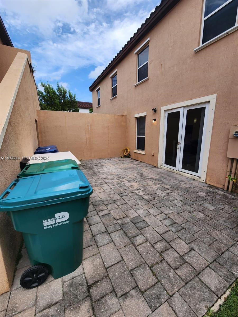 17005 Southwest 96th Street, Unit MAIN Miami, FL 33196 - Photo 18 of 19 a backyard of a house