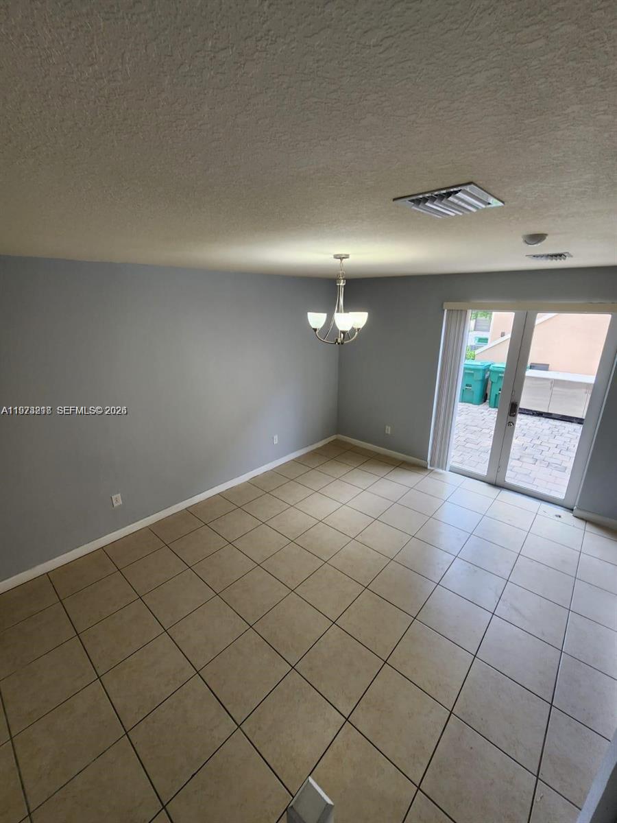 17005 Southwest 96th Street, Unit MAIN Miami, FL 33196 - Photo 2 of 19 a view of an empty room and window