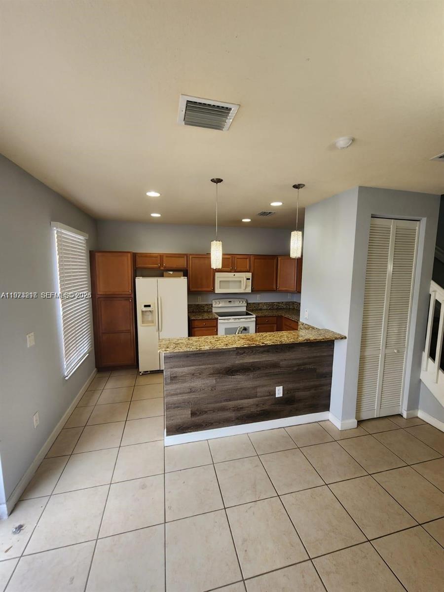 17005 Southwest 96th Street, Unit MAIN Miami, FL 33196 - Photo 3 of 19 a view of kitchen and window