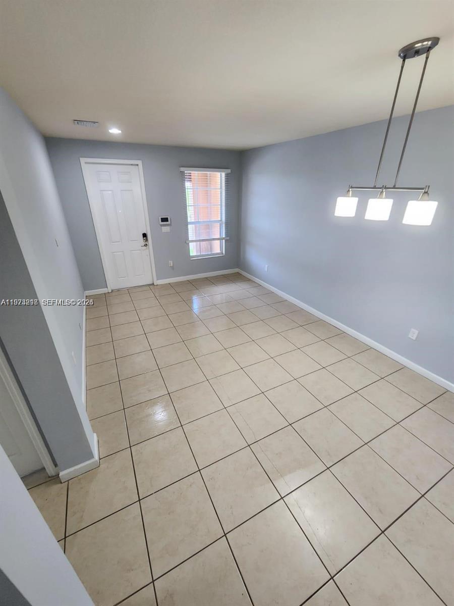 17005 Southwest 96th Street, Unit MAIN Miami, FL 33196 - Photo 5 of 19 a view of an empty room and window