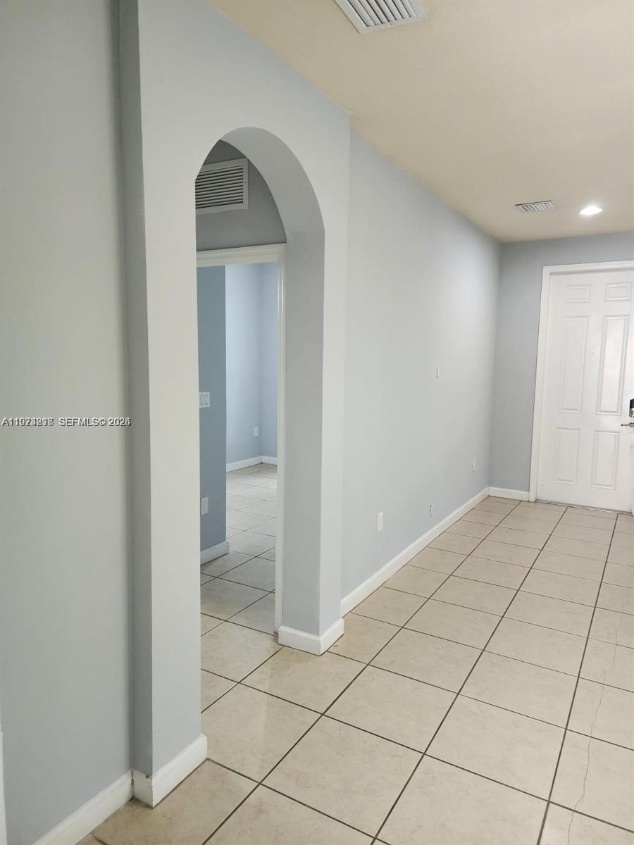 17005 Southwest 96th Street, Unit MAIN Miami, FL 33196 - Photo 6 of 19 a view of an empty room and window