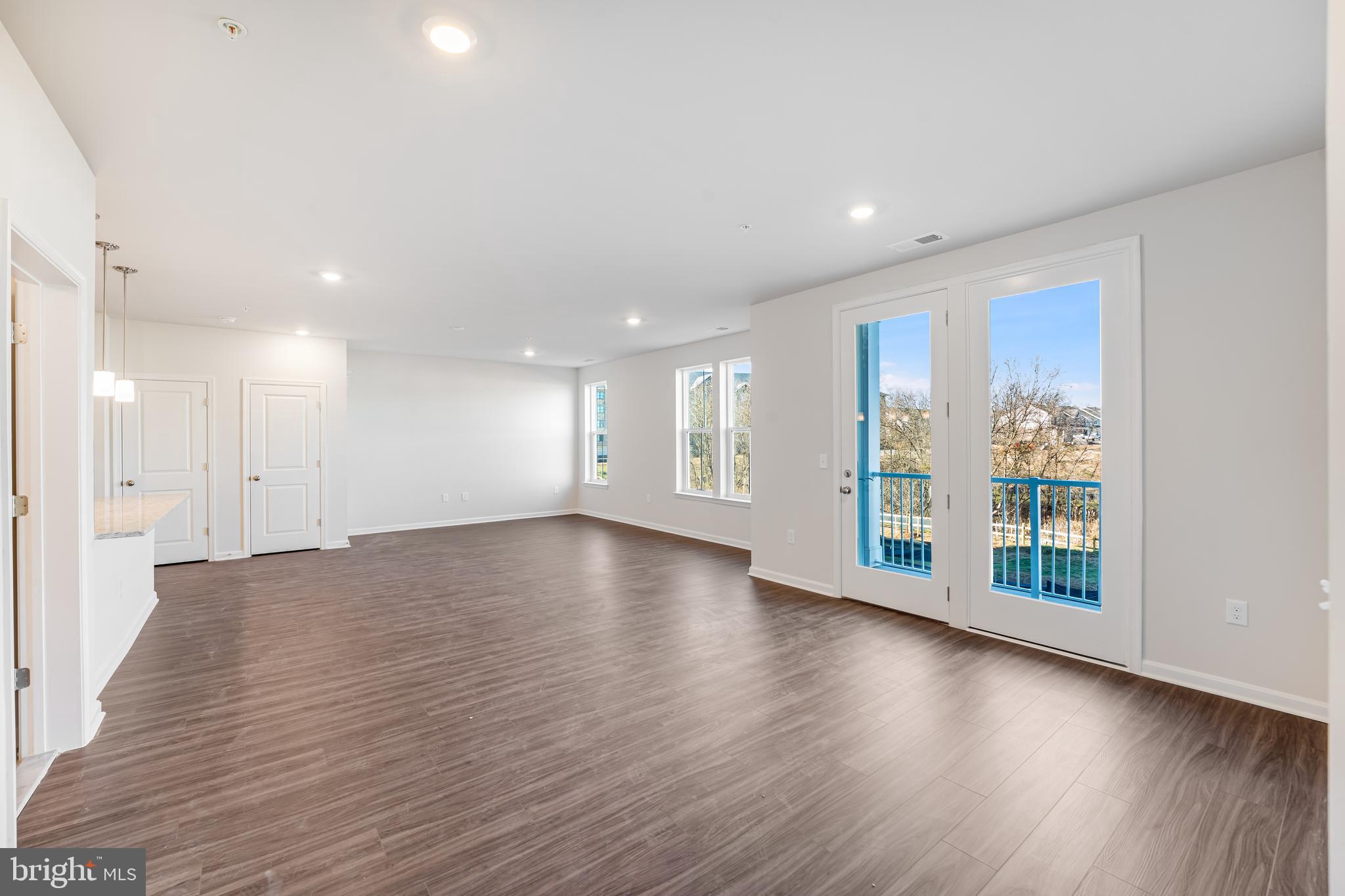 4003 Seaside Alder Road, Unit 206 LILY Bowie, MD 20720 - Photo 11 of 20 a view of an empty room with wooden floor and a window