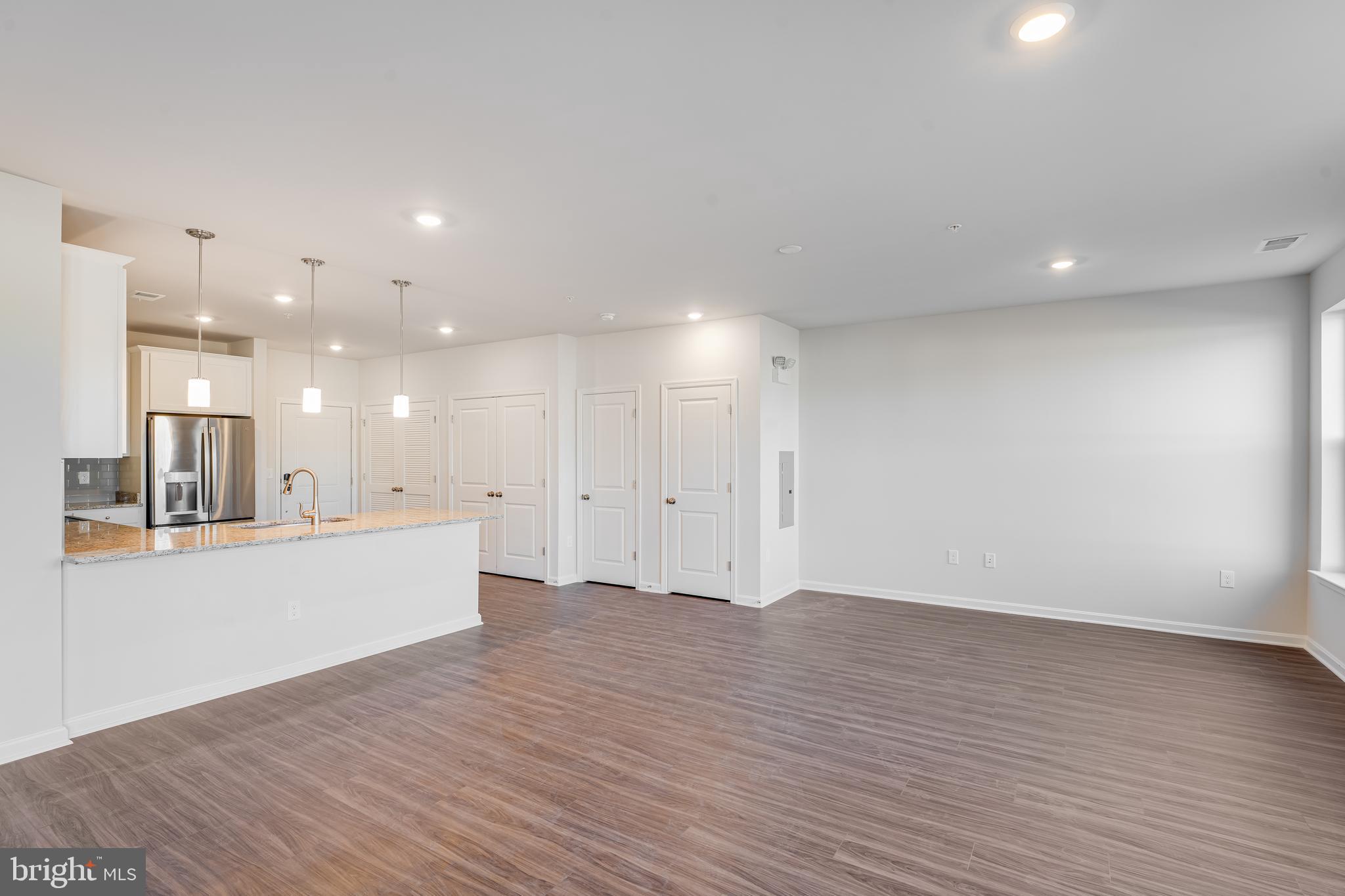 4003 Seaside Alder Road, Unit 206 LILY Bowie, MD 20720 - Photo 20 of 20 a view of an empty room with wooden floor