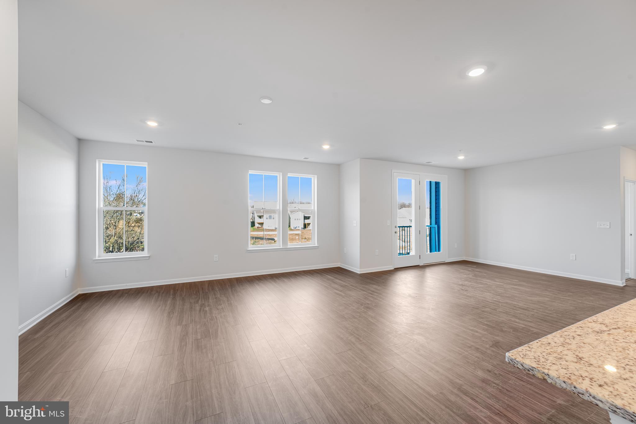4003 Seaside Alder Road, Unit 206 LILY Bowie, MD 20720 - Photo 8 of 20 a view of an empty room with wooden floor and a window