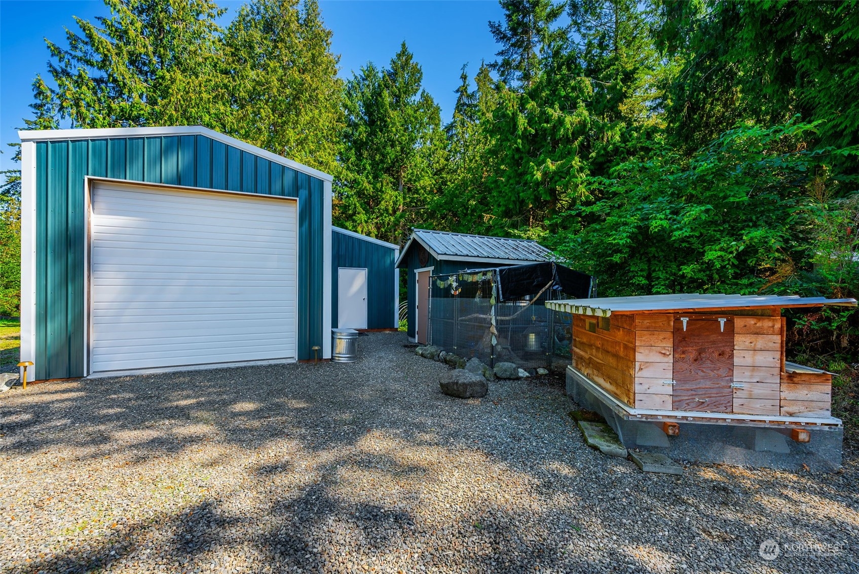 702 Sugar Hill Road Port Hadlock, WA 98339 - Photo 38 of 40 a backyard of a house with wooden fence and large trees
